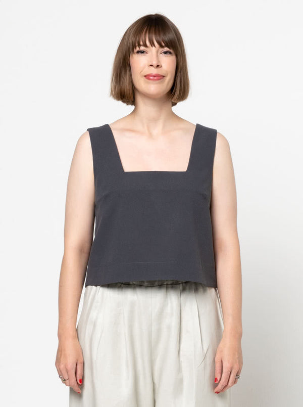 Image of the Byron Woven Top sewing pattern, highlighting the square neck, sleeveless design, and deep hem facing with topstitching, suitable for various elegant fabrics.