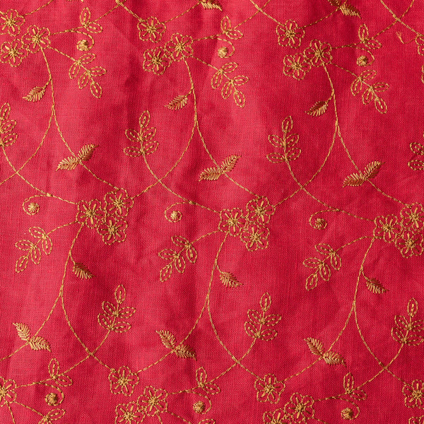 Elegant deep red linen fabric with dark golden floral embroidery, perfect for sophisticated projects.