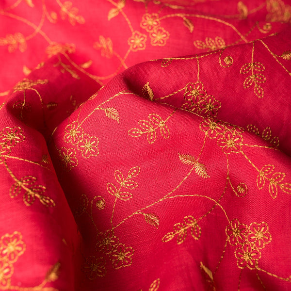 Elegant deep red linen fabric with dark golden floral embroidery, perfect for sophisticated projects.