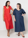 Two women wearing red and blue dresses made using a style arc Esther woven dress sewing pattern standing against a white background