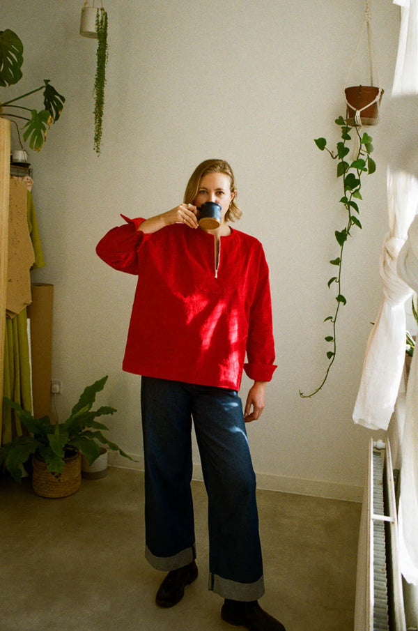 Customizable French Smock sewing pattern with options for button or zip fastening, various bib shapes, and optional trims, perfect for creating a unique garment.