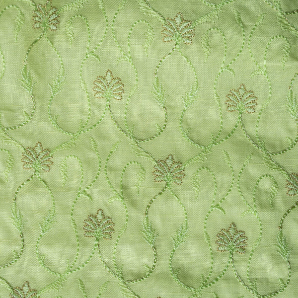 High-end vivid green linen fabric with subtle floral embroidery for luxury creations
