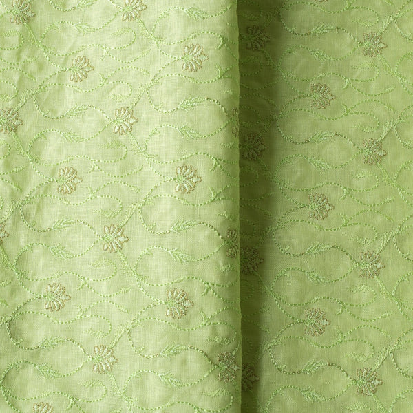 High-end vivid green linen fabric with subtle floral embroidery for luxury creations