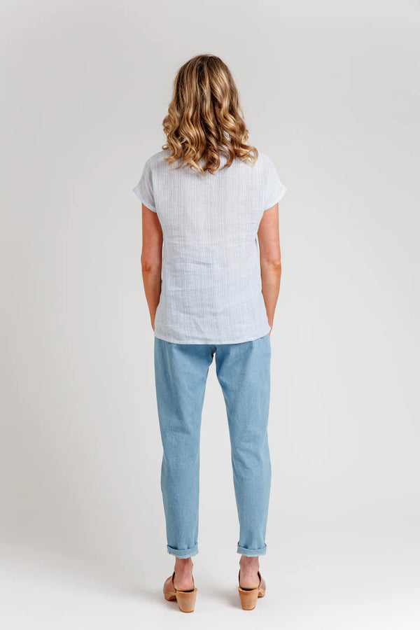 A relaxed silhouette Olive dress and top sewing pattern with a v-insert, drop shoulder, and multiple sleeve options, perfect for creating versatile garments.