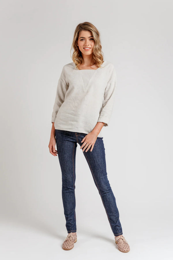 A relaxed silhouette Olive dress and top sewing pattern with a v-insert, drop shoulder, and multiple sleeve options, perfect for creating versatile garments.