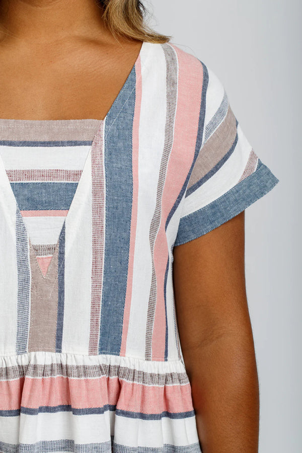 A relaxed silhouette Olive dress and top sewing pattern with a v-insert, drop shoulder, and multiple sleeve options, perfect for creating versatile garments.