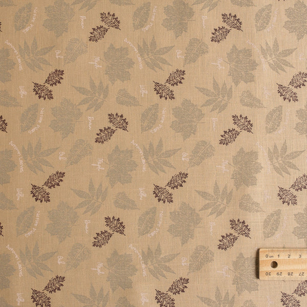 Nature-inspired Sand & Leaves linen fabric with a soft grip and leaf prints, perfect for creating stylish summer garments.