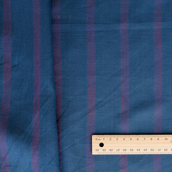 Tasman Tides linen fabric with deep blue base and vertical stripes in purple.