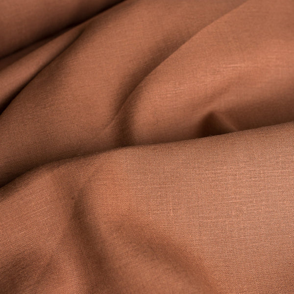 Rich, dark brown Tortoiseshell linen fabric, suitable for a range of stylish garments and cozy home textiles.