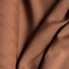 Rich, dark brown Tortoiseshell linen fabric, suitable for a range of stylish garments and cozy home textiles.