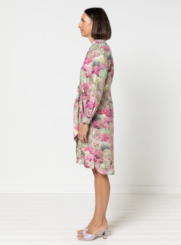 Woman wearing a floral dress made using Avon Woven Shirt and Dress sewing patternon a white background