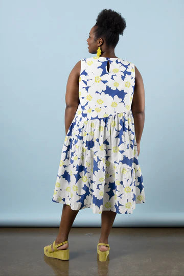 Woman wearing a floral dressmade using Azure Dress, Skirt, and Top sewing pattern with a blue background