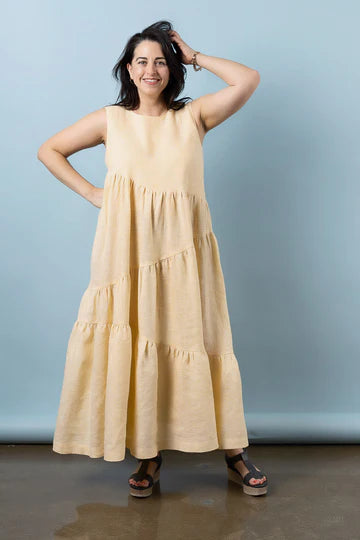Woman wearing a beige sleeveless dress made using Azure Dress, Skirt, and Top sewing patternmade using Azure Dress, Skirt, and Top sewing patternagainst a plain background