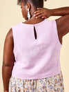 Woman wearing a light purple sleeveless top made using Azure Dress, Skirt, and Top sewing pattern with a beige background