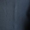 Close-up of darknavy blue linen fabric with folds