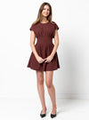 Woman wearing a maroon dress made using Bronte Woven Dress sewing pattern on a white background