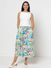 Woman wearing a white top and colorful patterned skirt Carter Dress made using StyleArc pattern on a white background