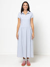 Woman wearing a light blue Carter Dress made using StyleArc patternwith a white background