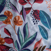 Close-up of colorful floral fabric pattern with leaves and flowers.