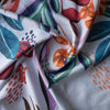 Colorful fabric with abstract leaf patterns on a white background