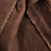 Close-up of Cocoa extra wide 100% linen fabricwith a visible seam