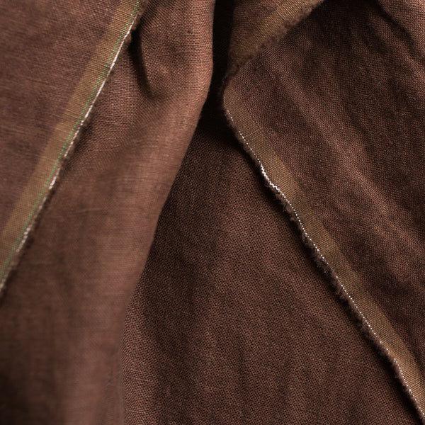Close-up of Cocoa extra wide 100% linen fabricwith a visible seam