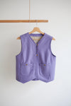 Purple vest on a wooden hanger against a white background Waistcoat made using Devon Waistcoat Sewing Pattern PDF – Relaxed fit, fully lined, reversible design with patch pockets and button or snap closures.