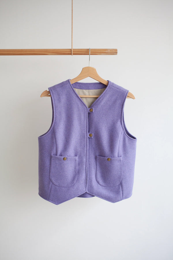 Purple vest on a wooden hanger against a white background Waistcoat made using Devon Waistcoat Sewing Pattern PDF – Relaxed fit, fully lined, reversible design with patch pockets and button or snap closures.