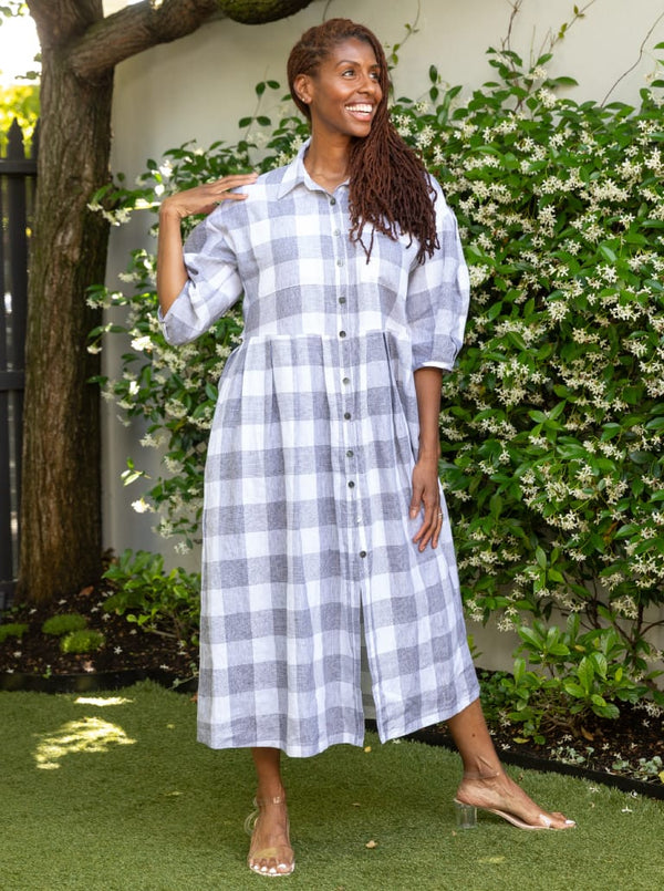 front view of Emerald Woven Shirt Dress sewing pattern featuring a waisted fit, irregular tucked skirt, shirt collar, optional sleeves or sleeveless style, and inseam pockets