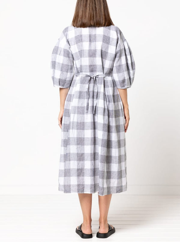 back view of Emerald Woven Shirt Dress sewing pattern featuring a waisted fit, irregular tucked skirt, shirt collar, optional sleeves or sleeveless style, and inseam pockets