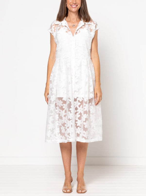 front view of Emerald Woven Shirt Dress sewing pattern featuring a waisted fit, irregular tucked skirt, shirt collar, optional sleeves or sleeveless style, and inseam pockets