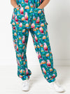 Person wearing teal scrubs with colorful parrot pattern on a white background
