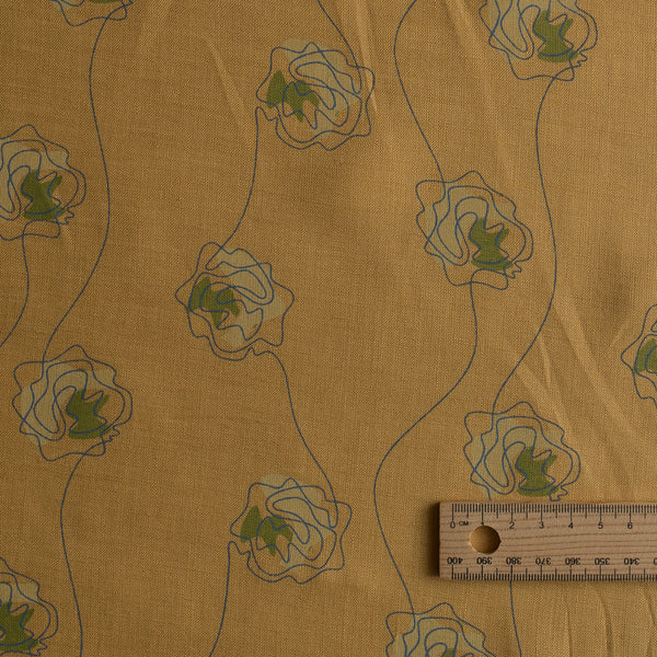 Golden Sketch Bloom linen fabric with golden mustard base and blue line-drawn floral design with green accent