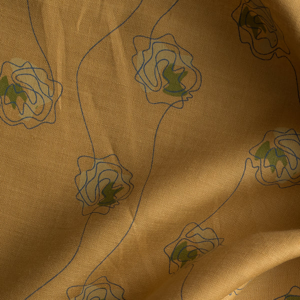 Golden Sketch Bloom linen fabric with golden mustard base and blue line-drawn floral design with green accent