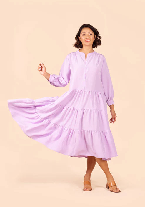 Woman wearing a light purple Poppy Dress against a beige background