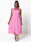 Woman wearing a pink checkered dress on a white background. the dress made using Hampton Woven Dress Sewing Pattern – Mid-calf shirtdress with gathered skirt, curved waist, sleeve or sleeveless options, and inseam pockets.