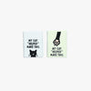 Two small rectangular signs with text and a cat illustration on a white background