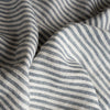 Close-up of Marine Stripe 100% Linen Fabric with blue and white horizontal lines.