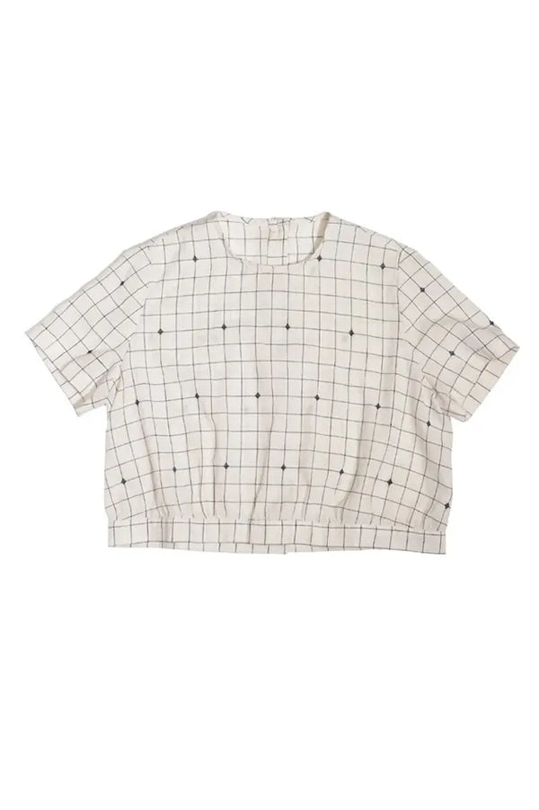 Grid-patterned top made using The Celeste Sewing Pattern by Merchant & Mills – feminine blouse with back buttons and gathered waiston a white background