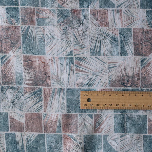Lightweight linen-cotton blend fabric with palm leaf block print in white silhouette, brown and dark teal, named “Outback Oasis.