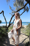 Pipit Vest Sewing Pattern - Reversible Oversized Vest in Two Lengths. Image of A woman wearing pipit vest made of natural colour linen fabric in the beach side
