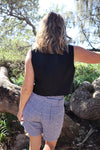 Pipit Vest Sewing Pattern - Reversible Oversized Vest in Two Lengths. Image of A woman wearing pipit vest made of black colour linen fabric in the beach side