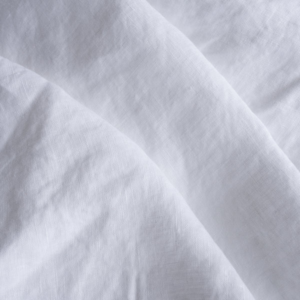 Close-up of extra wide whitelinen fabric with folds