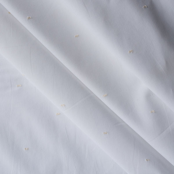 Pure White with Ivory Dot Giza Cotton Blend Fabric with small ivory embroidered dots on a white base
