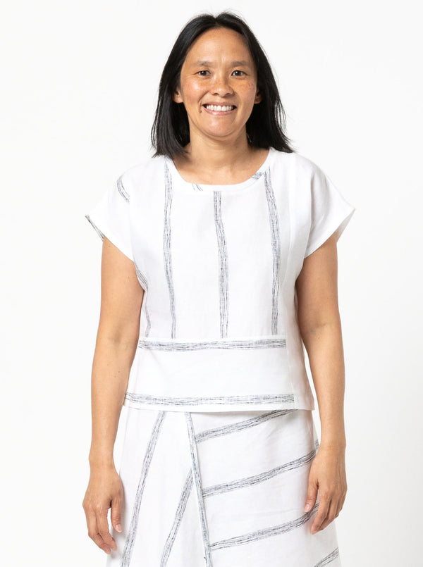 Quinn Woven Top sewing pattern with square cut, extended shoulder line, boxy shape, and front and back panelling.