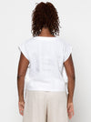 Person wearing a white top with sheer sleeves made using Rumi Top Sewing Pattern on a plain background