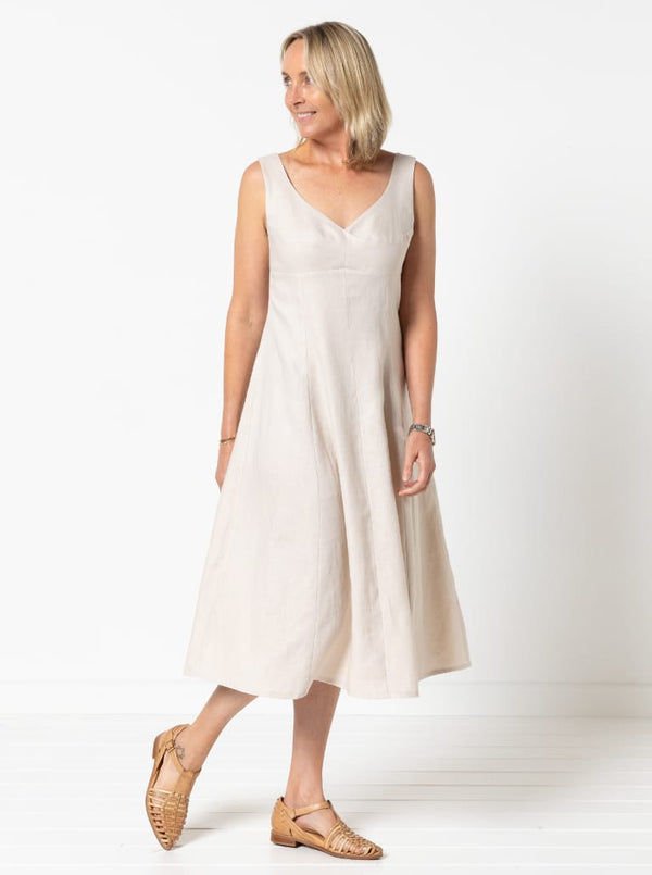 A sophisticated sleeveless dress with a high-waisted fitted bodice, gored skirt, and invisible zip, made from luxurious linen fabric.