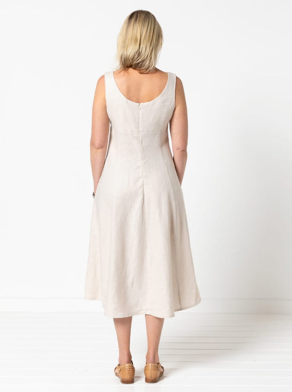 A sophisticated sleeveless dress with a high-waisted fitted bodice, gored skirt, and invisible zip, made from luxurious linen fabric.