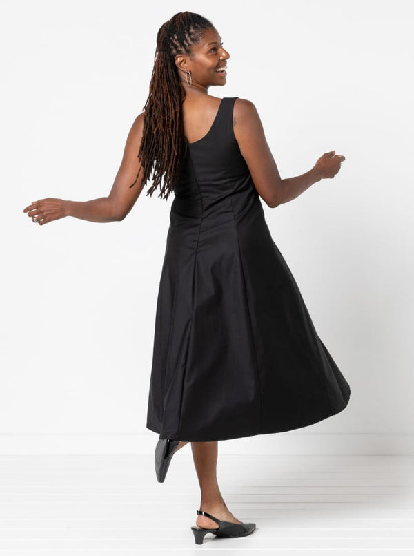 A sophisticated sleeveless dress with a high-waisted fitted bodice, gored skirt, and invisible zip, made from luxurious linen fabric.