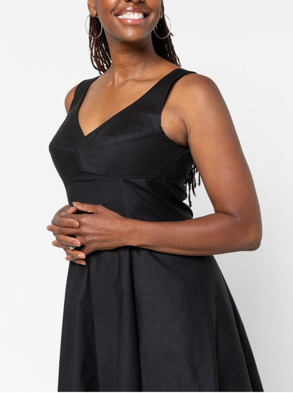 A sophisticated sleeveless dress with a high-waisted fitted bodice, gored skirt, and invisible zip, made from luxurious linen fabric.